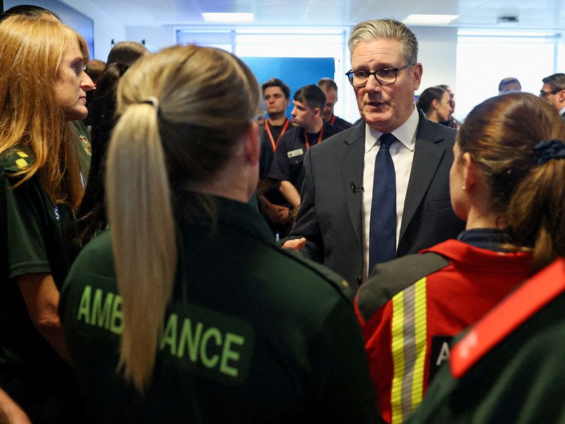 Britain's Prime Minister Keir Starmer talks with Ambulance staff