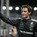 Mercedes' British driver George Russell celebrates getting pole position after the qualifying session for the Formula One Singapore Grand Prix night race