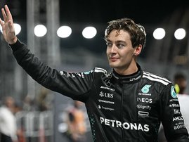 Mercedes' British driver George Russell celebrates getting pole position after the qualifying session for the Formula One Singapore Grand Prix night race