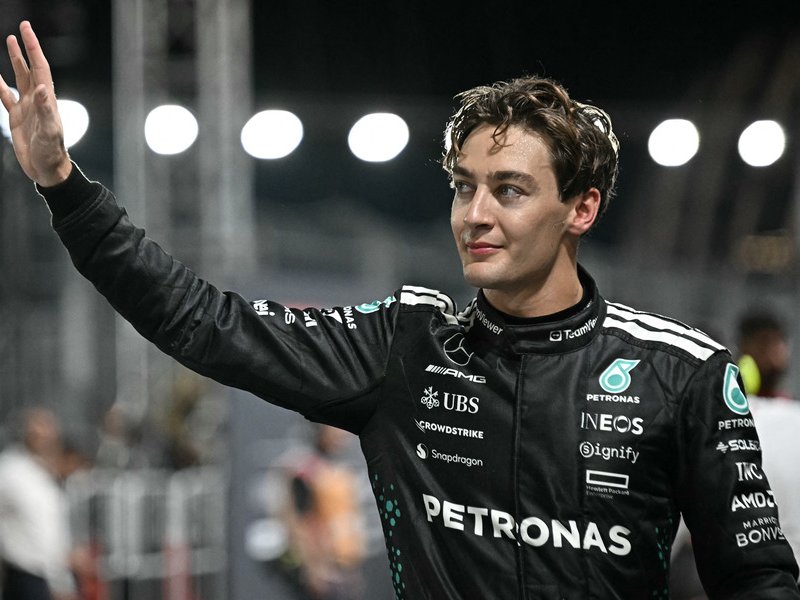 Mercedes' British driver George Russell celebrates getting pole position after the qualifying session for the Formula One Singapore Grand Prix night race