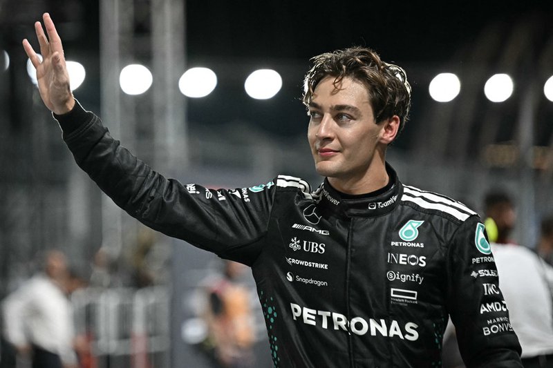 Mercedes' British driver George Russell celebrates getting pole position after the qualifying session for the Formula One Singapore Grand Prix night race