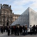 Louvre Museum Visitors queue in front of the Pyramide du Louvre
