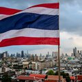 Thailand's national flag flies over the city skyline in Bangkok