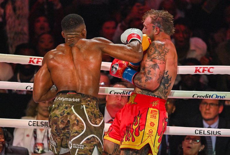 US boxer and influencer Jake Paul (R) fights British boxer Anthony Joshua in a non-title heavyweight bout at the Kaseya Center in Miami, Florida
