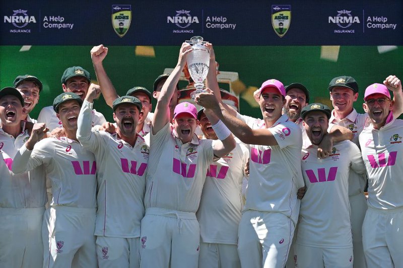 Australian players celebrate with the Waterford Crystal Ashes Trophy at the end of the fifth Ashes cricket Test between Australia and England