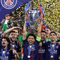 Paris Saint-Germain's Brazilian defender #05 Marquinhos lifts the trophy as he celebrates with teammates winning the UEFA Champions League final football match
