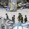 Japanese soldiers work outside the damaged Aeon Mall Kumamoto in Kashima