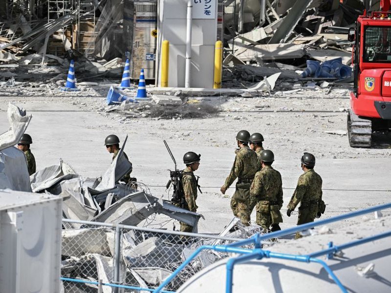 Japanese soldiers work outside the damaged Aeon Mall Kumamoto in Kashima