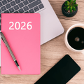 A 2026 planner lying on a desk workspace