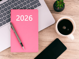 A 2026 planner lying on a desk workspace