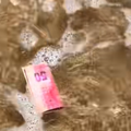 A R50 note floating in the beach water