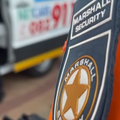 A Security officer security badge in front of an ambulance