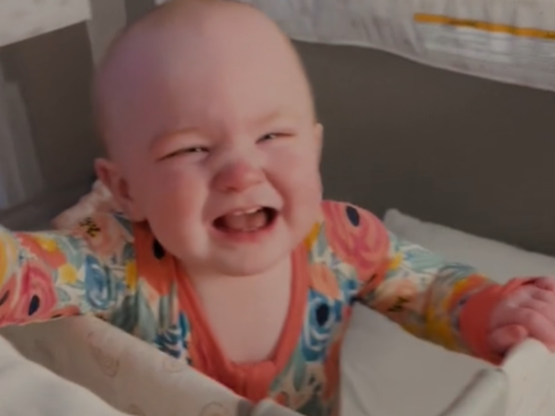 A baby crying while inside her crib