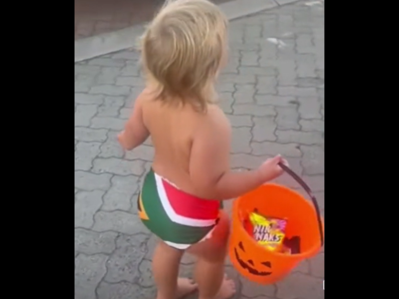 A baby is dressed like Faf de Klerk for Halloween