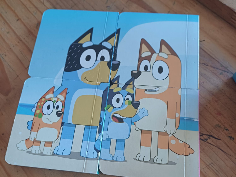 A book puzzle of Bluey and her family
