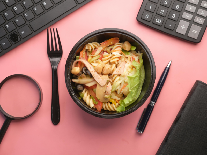 A bowl of food left near a workstation of a person in the office