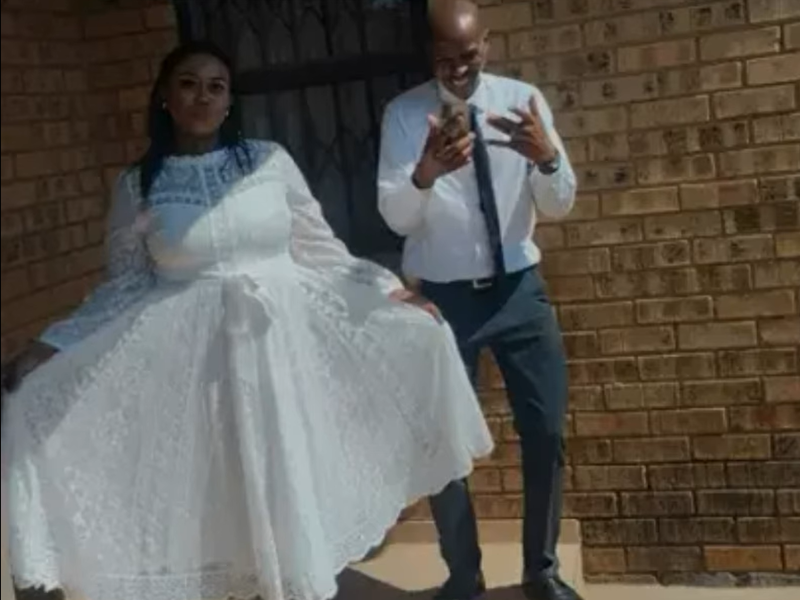 A bride wearing a wedding dress next to her groom