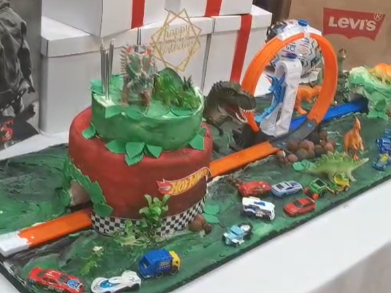 A cake with a race track for a birthday