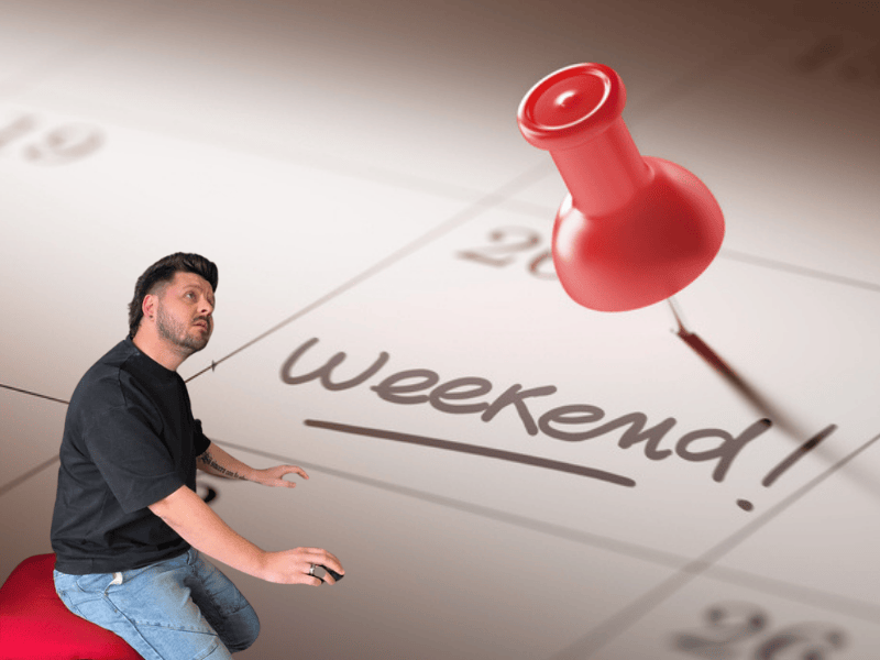 A calendar with a red pin attached to the weekend date and Danny Guselli looking at it