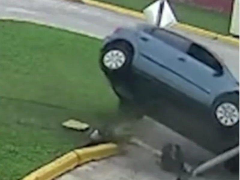A car crashes into a light pole
