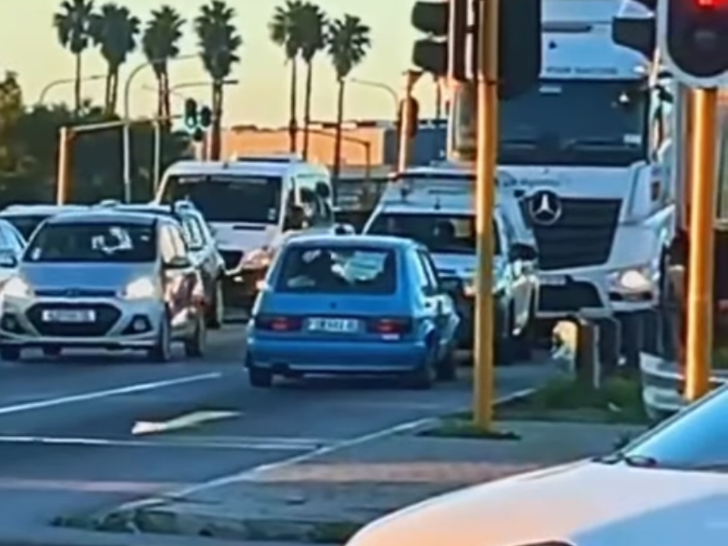A car reversing after driving on the wrong lane