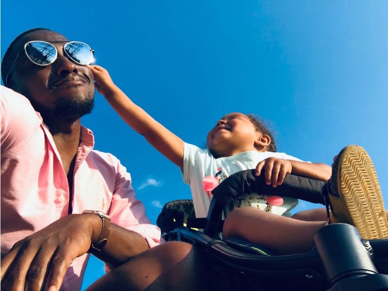 A child touching her father's face