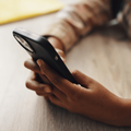 A child using a smartphone to access games or social media