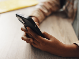 A child using a smartphone to access games or social media