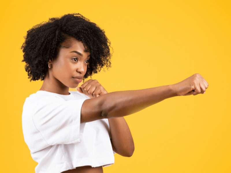 A confident black woman in a fighting pose