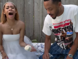 A couple holding champagne flutes after finding out the gender of their baby