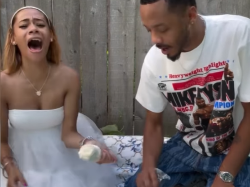 A couple holding champagne flutes after finding out the gender of their baby