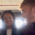 A couple laugh with one another at an outdoor eatery