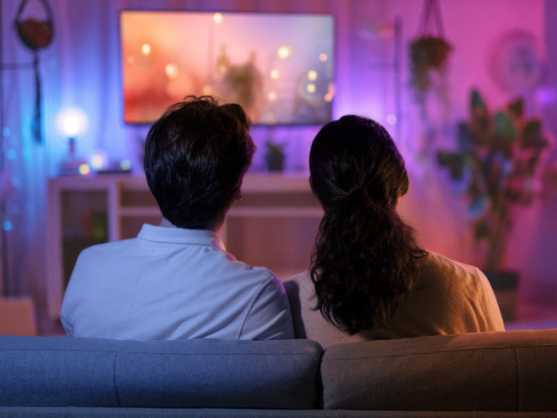 A couple watching a movie on television