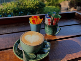 A cup of coffee on a wooden table at a cafe in the Bluff
