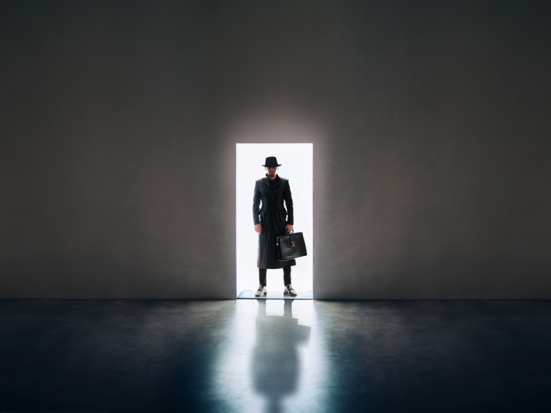 A detective standing in a doorway.png