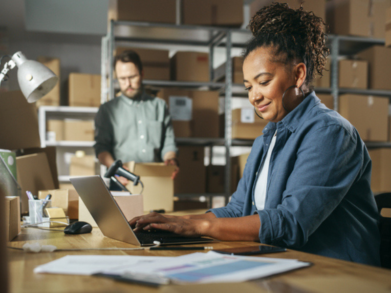 A diverse male and female work in a warehouse inventory