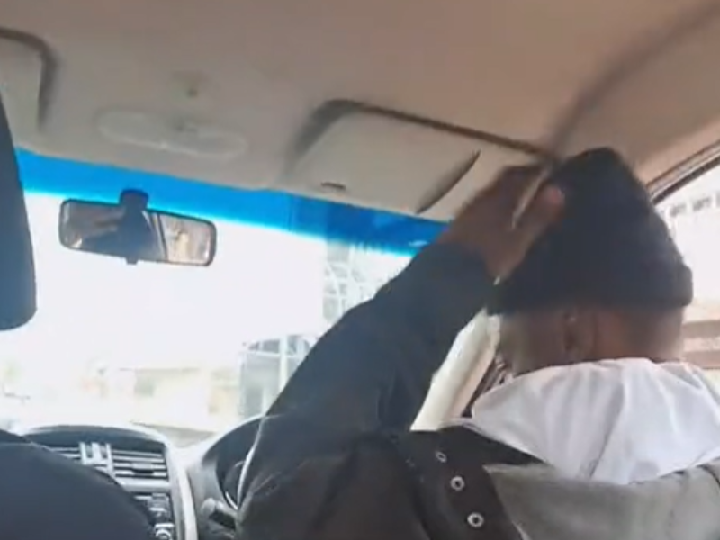 A driver holds his head whilst driving