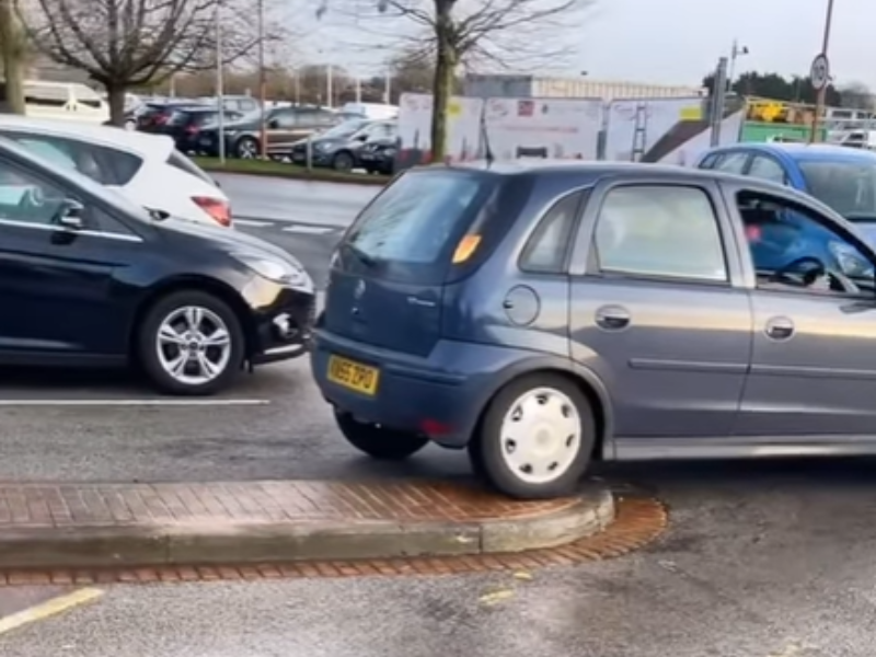 A driver trying to reverse into a parking space