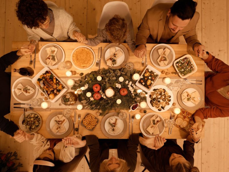 A family giving thanks before Christmas dinner