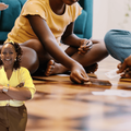 A family playing cards on their living room floor