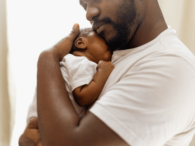 A father caring for his newborn baby