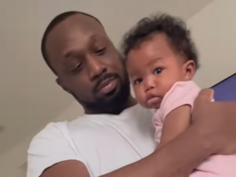 A father carries his baby girl