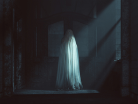 A female ghost covered in a white sheet
