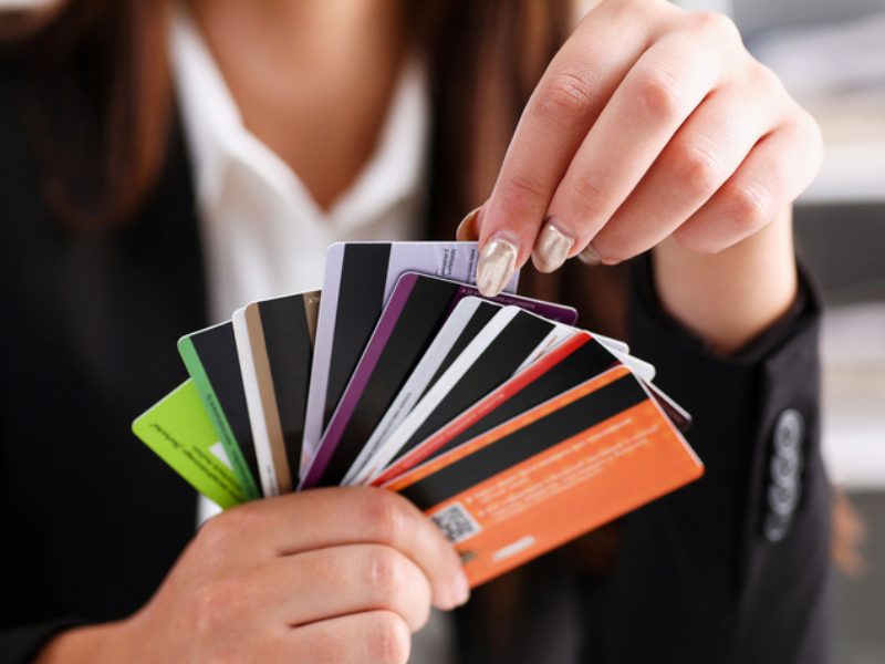 A female holds a bunch of cards in her hand