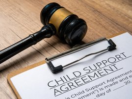 A gavel on a child support agreement document
