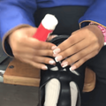 A girl glues the front of a school shoe together