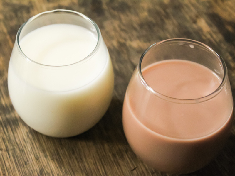 A glass of chocolate milk and plain milk
