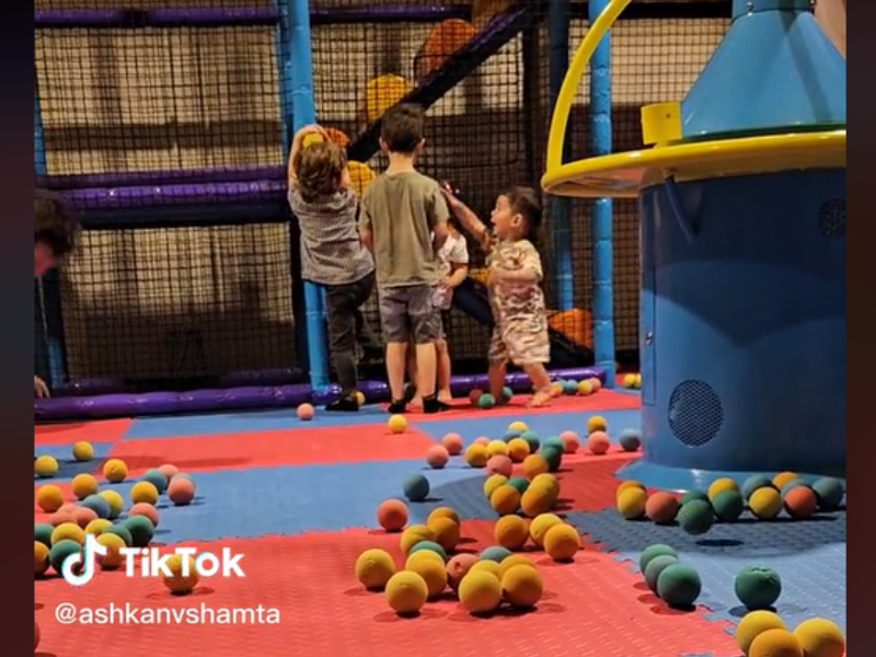 A group of kids playing at indoor jungle gym