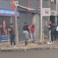 A group of people clean up a street side in Durban
