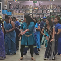 A group of people dance in the middle of a store